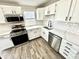 Well-lit kitchen features stainless appliances, modern countertops, and a white subway tile backsplash at 5608 Lunsford Dr, Indianapolis, IN 46237