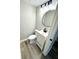 Well-appointed half bathroom featuring modern fixtures and a stylish vanity and mirror at 5608 Lunsford Dr, Indianapolis, IN 46237