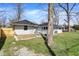 Backyard view of the home showcasing the fresh gravel, and spacious yard at 5887 Meadowlark Dr, Indianapolis, IN 46226