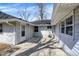 Backyard patio area with a white siding, a hose, and a door entrance at 5887 Meadowlark Dr, Indianapolis, IN 46226