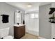 Updated bathroom featuring a wood vanity, modern fixtures, and shower with a window at 5887 Meadowlark Dr, Indianapolis, IN 46226