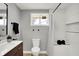 Updated bathroom with white shower tiles, modern vanity and fixtures, and light gray walls at 5887 Meadowlark Dr, Indianapolis, IN 46226