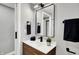 Stylish bathroom featuring a wood vanity, black fixtures, and sleek mirror at 5887 Meadowlark Dr, Indianapolis, IN 46226