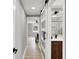 View from the hall through sliding glass doors, a bathroom with a dark wood vanity and a bedroom at the end of the hall at 5887 Meadowlark Dr, Indianapolis, IN 46226