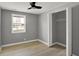 Neutral bedroom featuring hardwood floors, a ceiling fan, and a closet at 5887 Meadowlark Dr, Indianapolis, IN 46226