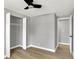 Bedroom featuring a ceiling fan, closet, neutral paint, and access to another room at 5887 Meadowlark Dr, Indianapolis, IN 46226