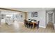 Inviting dining area with wood table, flowing to an open kitchen, and sleek finishes at 5887 Meadowlark Dr, Indianapolis, IN 46226