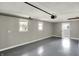 Spacious garage with painted floors, white ceiling, and two windows at 5887 Meadowlark Dr, Indianapolis, IN 46226