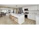 Renovated kitchen features white cabinets, stainless steel appliances, a large island with seating, and open layout at 5887 Meadowlark Dr, Indianapolis, IN 46226
