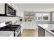 Modern kitchen featuring white cabinets, stainless steel appliances, and a breakfast bar at 5887 Meadowlark Dr, Indianapolis, IN 46226