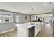 Bright, open kitchen featuring an island with seating, stainless steel appliances, and wood-style flooring at 5887 Meadowlark Dr, Indianapolis, IN 46226