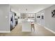 Spacious kitchen with white cabinets, stainless steel appliances, island, and adjacent eat-in area at 5887 Meadowlark Dr, Indianapolis, IN 46226