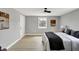 This bedroom has light gray walls, light-colored wood floors, and a queen-size bed with nightstands at 5887 Meadowlark Dr, Indianapolis, IN 46226