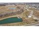 Aerial view of a serene pond in a community, with houses being built nearby at 6011 Card Blvd, Indianapolis, IN 46221