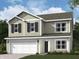 Charming two-story home with attached garage and inviting curb appeal on a beautifully landscaped lawn at 6011 Card Blvd, Indianapolis, IN 46221