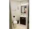 Well-lit bathroom featuring a modern vanity, toilet, and neutral tile flooring at 611 N Park Ave # 405, Indianapolis, IN 46204