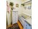 Charming Bedroom featuring a white crib, changing table, dresser, and stylish decor at 611 N Park Ave # 405, Indianapolis, IN 46204