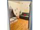 Delightful Bedroom featuring hardwood floors, whimsical decor, daybed, and a cozy atmosphere at 611 N Park Ave # 405, Indianapolis, IN 46204