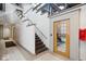 Hallway featuring tile floors, stairs, and fitness center beyond the door at 611 N Park Ave # 405, Indianapolis, IN 46204