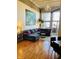 Spacious living room boasts hardwood floors, large sectional sofa, and ample natural light at 611 N Park Ave # 405, Indianapolis, IN 46204