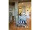 Inviting living room featuring hardwood floors, stairs with -proof gate, and a partial view of the kitchen at 611 N Park Ave # 405, Indianapolis, IN 46204