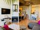 Open-concept living space with fireplace, adjacent dining area, and access to kitchen at 611 N Park Ave # 405, Indianapolis, IN 46204