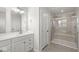 Modern bathroom with a large vanity, glass shower and tile surround at 629 Washington St, Fortville, IN 46040