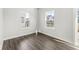 Well-lit bedroom with hardwood floors and views of the outdoors through large windows at 629 Washington St, Fortville, IN 46040