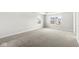 Large bedroom with natural light, plush carpet, and neutral paint at 629 Washington St, Fortville, IN 46040