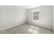 Cozy carpeted bedroom with natural light from a single window at 629 Washington St, Fortville, IN 46040