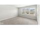 Bedroom with plush carpeting and multiple windows providing natural light at 629 Washington St, Fortville, IN 46040