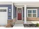 Inviting entryway with a red door, brick accents, and classic architectural details, creating a warm welcome at 629 Washington St, Fortville, IN 46040