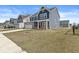 Suburban home with blue siding, a two-car garage, and a spacious yard, set in a Gathering-friendly neighborhood at 629 Washington St, Fortville, IN 46040