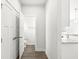Bright hallway featuring wood floors, closet, and an adjacent bathroom with modern fixtures at 629 Washington St, Fortville, IN 46040