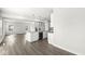 Bright kitchen with granite counters and stainless steel appliances overlooks the hardwood floor living space at 629 Washington St, Fortville, IN 46040