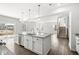Open kitchen featuring granite countertops, island, and stainless steel appliances in a modern design at 629 Washington St, Fortville, IN 46040