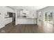 Open layout kitchen features stainless steel appliances, granite island, and access to outdoor living space at 629 Washington St, Fortville, IN 46040