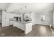 Modern kitchen with granite countertops, a center island, and stainless steel appliances open to living area at 629 Washington St, Fortville, IN 46040