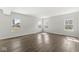 Spacious living room featuring sleek hardwood floors and multiple windows, filling the room with natural light at 629 Washington St, Fortville, IN 46040