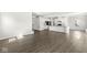 Open-concept living area showcasing a modern kitchen with a breakfast bar and hardwood floors at 629 Washington St, Fortville, IN 46040
