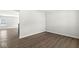 Bright, modern living room featuring sleek hardwood floors and ample natural light from a large window at 629 Washington St, Fortville, IN 46040