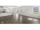 Bright living room features hardwood floors and an open floor plan with a view into the kitchen at 629 Washington St, Fortville, IN 46040