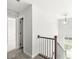 Bright staircase featuring a wooden railing and a view to the outside at 629 Washington St, Fortville, IN 46040