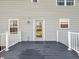A view of the back deck, showing the back door and gray siding at 6746 Wilmot Ln, Avon, IN 46123