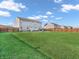 Expansive backyard featuring lush green grass and a privacy fence at 6746 Wilmot Ln, Avon, IN 46123