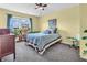 Inviting bedroom with a comfy bed, a window with blue curtains, and plants at 6746 Wilmot Ln, Avon, IN 46123