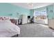 Bright bedroom with a large window, a ceiling fan, a dresser, and aqua colored walls at 6746 Wilmot Ln, Avon, IN 46123