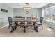 Stylish dining room with a rustic table, comfortable seating, and ample natural light, ideal for gatherings at 6746 Wilmot Ln, Avon, IN 46123