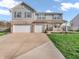 Charming two-story home with a two-car garage, well-manicured lawn, and inviting front porch seating at 6746 Wilmot Ln, Avon, IN 46123