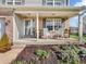 Welcoming front porch with cozy seating, beautiful landscaping, and charming details that enhance curb appeal at 6746 Wilmot Ln, Avon, IN 46123
